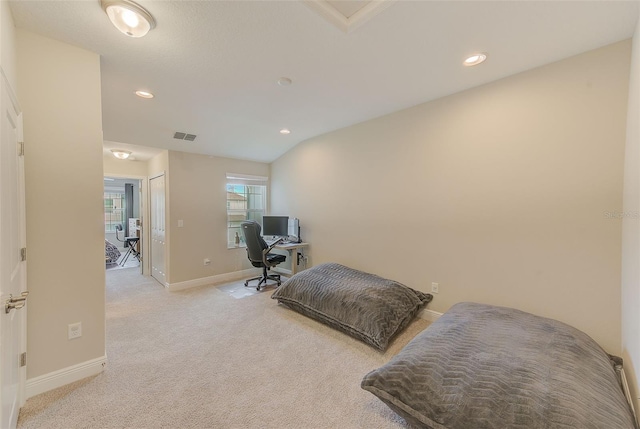 exercise room featuring lofted ceiling and light carpet