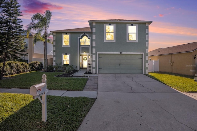 view of front of house featuring a lawn and a garage