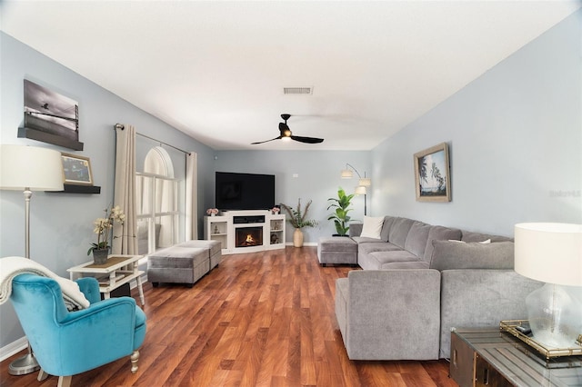 living room with dark hardwood / wood-style floors and ceiling fan