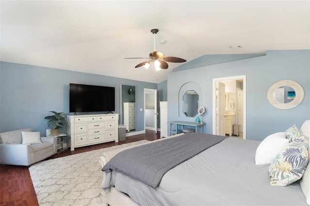 bedroom with ceiling fan, dark hardwood / wood-style floors, ensuite bath, and vaulted ceiling