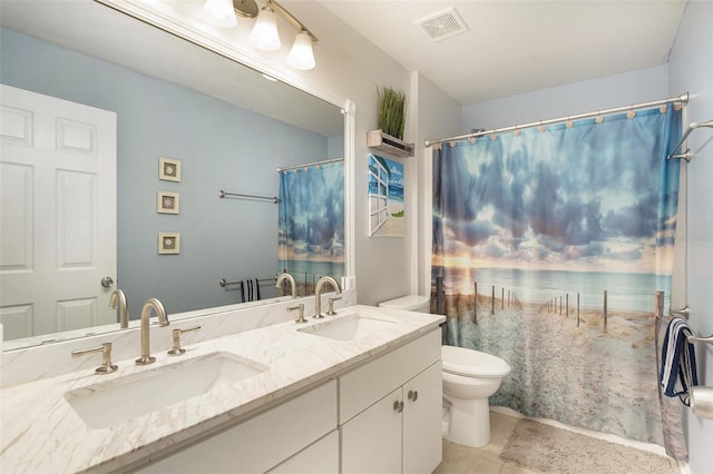 bathroom featuring tile patterned flooring, vanity, and toilet