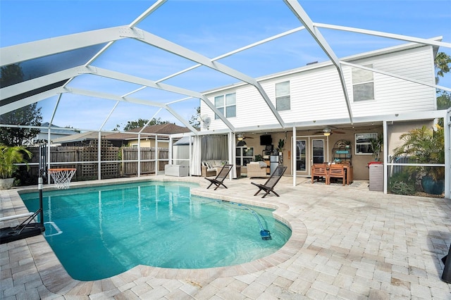 view of pool featuring a lanai, a patio area, and ceiling fan