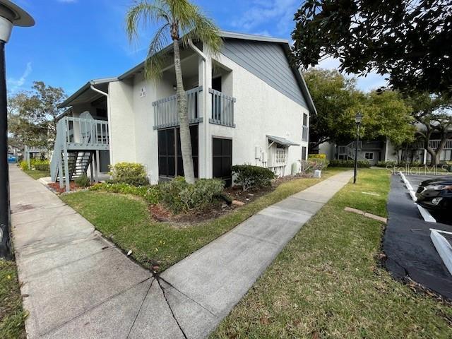 view of side of home with a yard