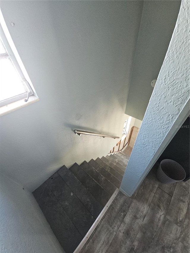 stairs featuring hardwood / wood-style floors