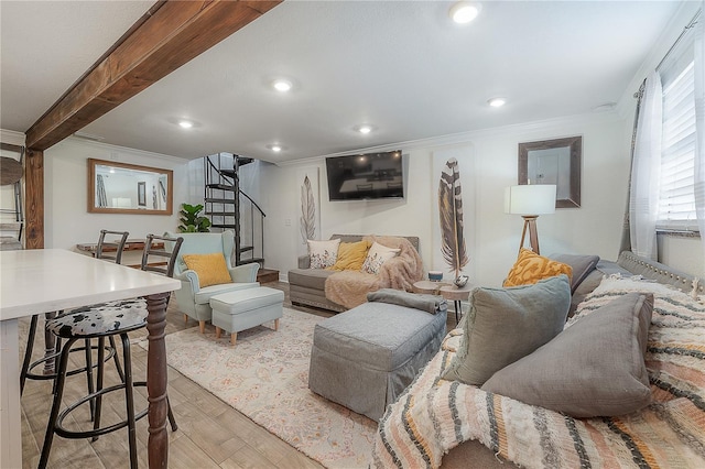 living room featuring beam ceiling, crown molding, and light hardwood / wood-style flooring