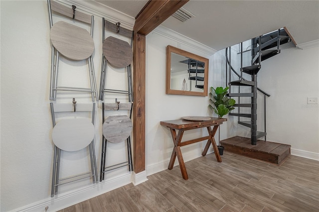 interior space with beam ceiling and crown molding