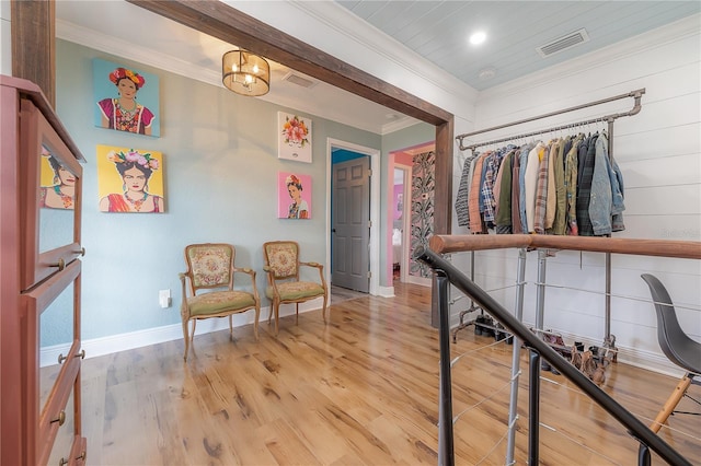 sitting room featuring crown molding and hardwood / wood-style floors