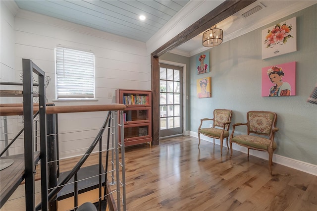 sitting room with a chandelier, crown molding, and hardwood / wood-style flooring