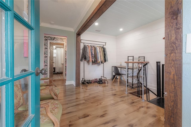 interior space featuring light wood-type flooring and crown molding