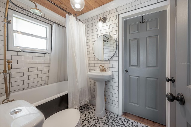 bathroom featuring toilet, shower / tub combo with curtain, ornamental molding, and wooden ceiling