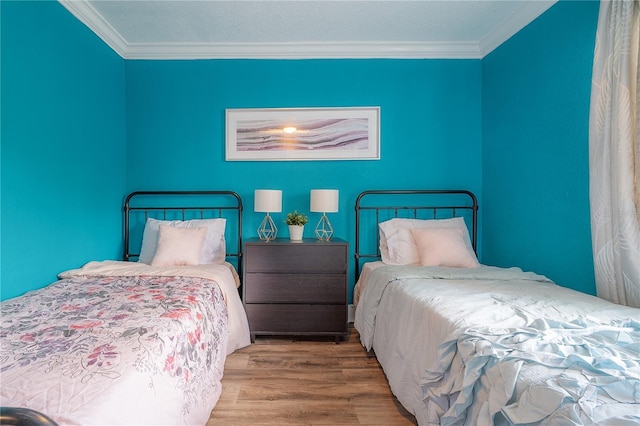 bedroom with crown molding and hardwood / wood-style flooring