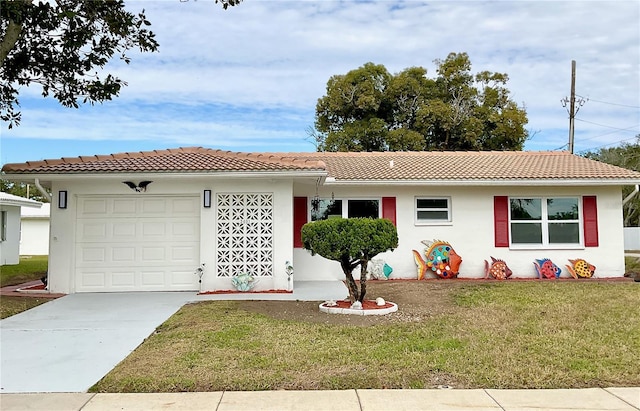 view of front of home featuring a garage and a front lawn