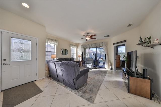 tiled living room featuring ceiling fan