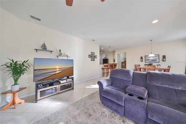 living room featuring ceiling fan and light tile patterned floors