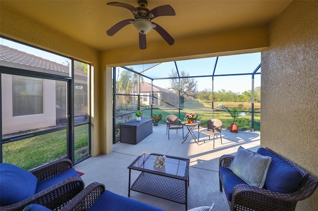 sunroom / solarium featuring ceiling fan