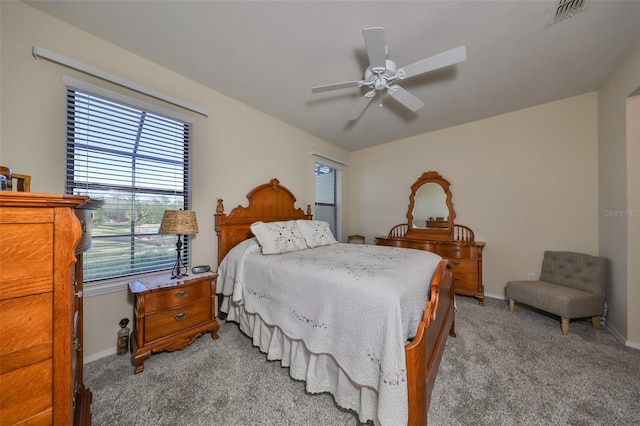 bedroom featuring light colored carpet and ceiling fan