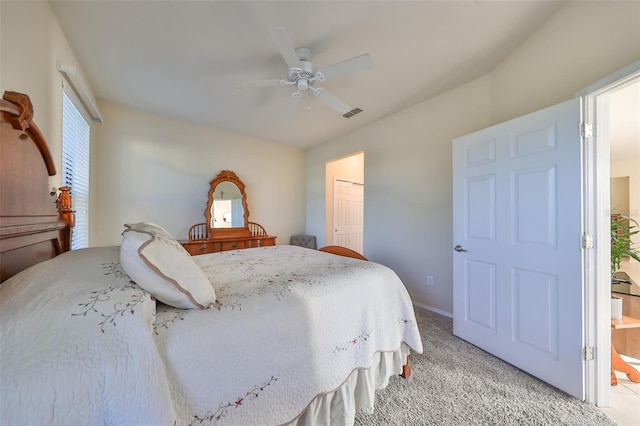 carpeted bedroom featuring connected bathroom, a closet, and ceiling fan