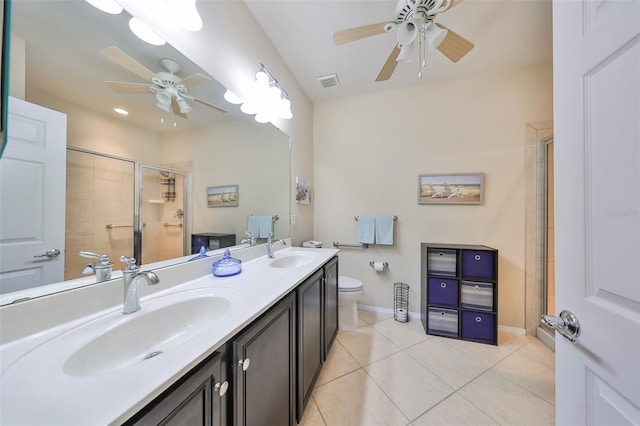 bathroom featuring an enclosed shower, vanity, ceiling fan, tile patterned flooring, and toilet