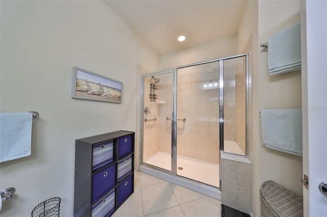 bathroom with tile patterned flooring and a shower with door