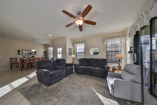 living room featuring ceiling fan and light tile patterned floors