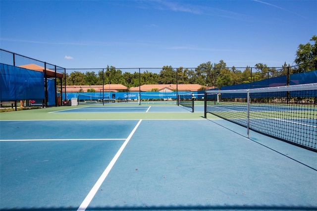 view of tennis court featuring basketball hoop