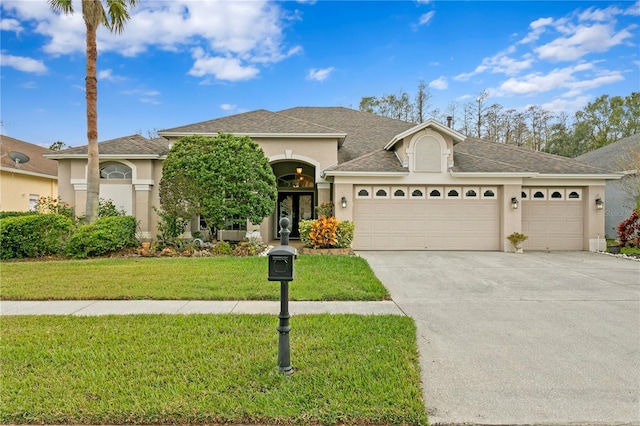 view of front facade featuring a front yard and a garage