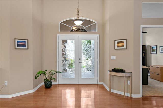 foyer entrance featuring french doors and hardwood / wood-style flooring