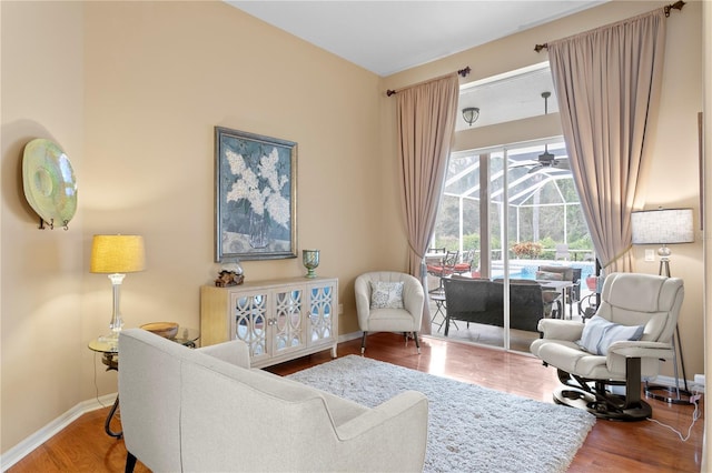 sitting room with ceiling fan and hardwood / wood-style flooring