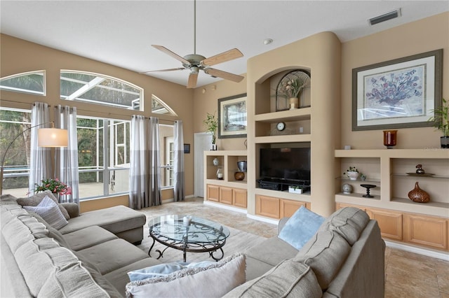 living room featuring built in features and ceiling fan