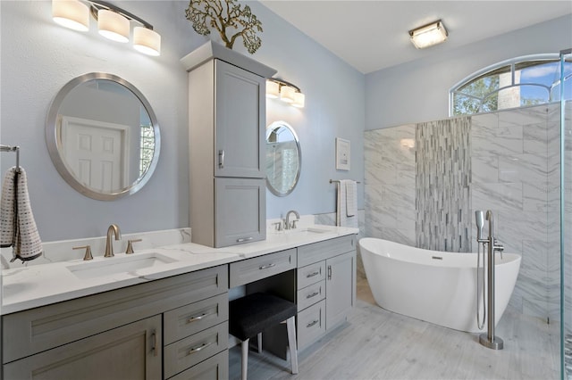 bathroom featuring a washtub and vanity