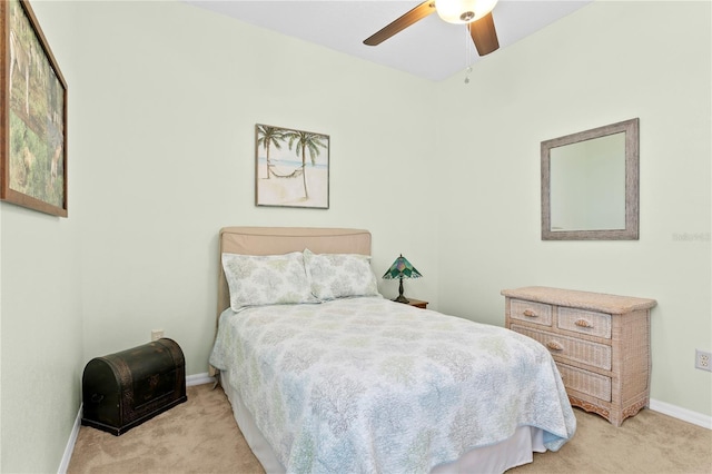 bedroom featuring ceiling fan and light carpet