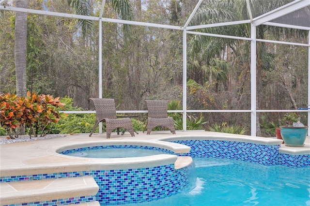 view of pool featuring glass enclosure and a patio