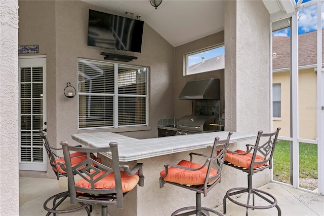 view of patio / terrace with exterior bar and grilling area