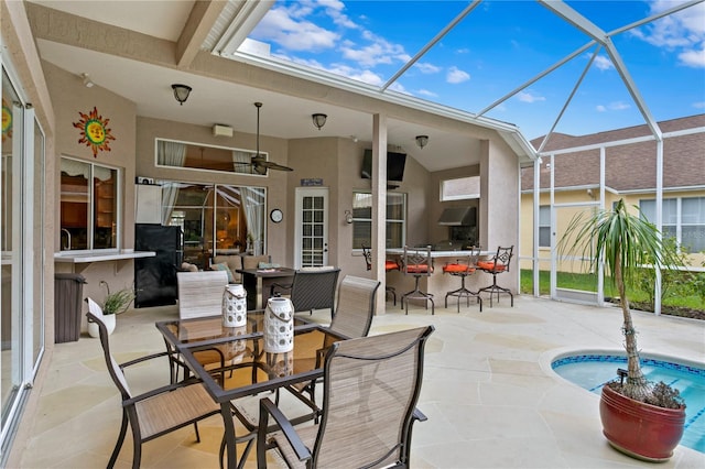 sunroom featuring ceiling fan and a swimming pool