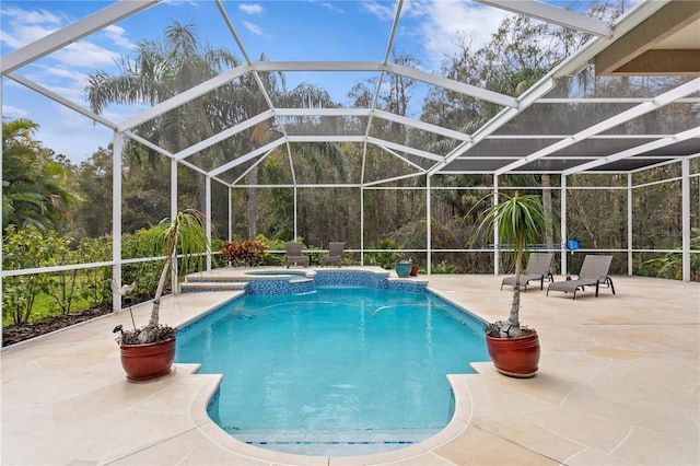 view of swimming pool with a lanai, an in ground hot tub, and a patio