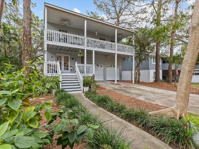 view of front of home featuring french doors, a balcony, and a garage