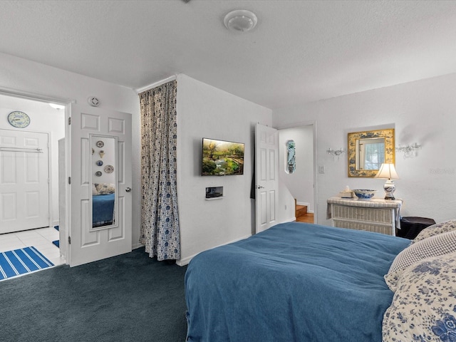 carpeted bedroom with a textured ceiling