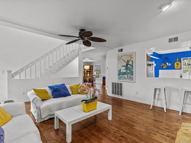 living room featuring ceiling fan, lofted ceiling, and wood-type flooring