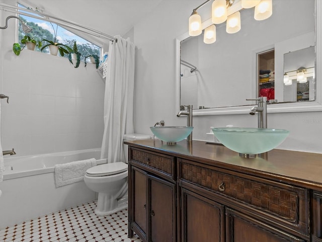 full bathroom with tile patterned floors, toilet, shower / bathtub combination with curtain, and vanity