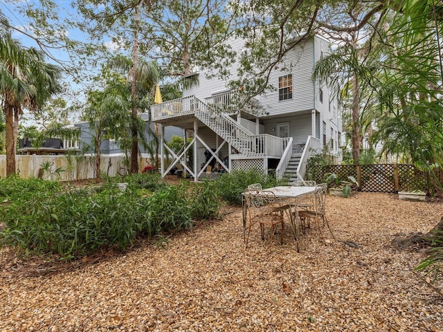 rear view of house featuring a wooden deck