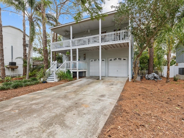 view of front of house featuring a balcony, a porch, and a garage