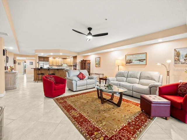 tiled living room with ceiling fan