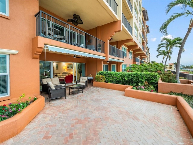 view of patio / terrace featuring ceiling fan, a balcony, and an outdoor living space