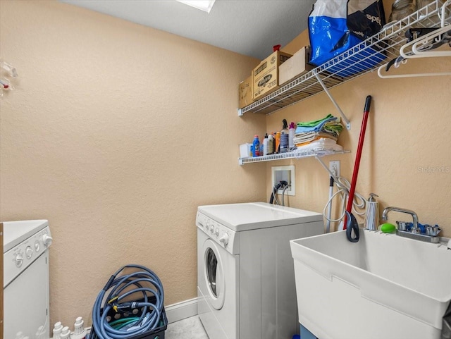 laundry room featuring sink and washing machine and clothes dryer