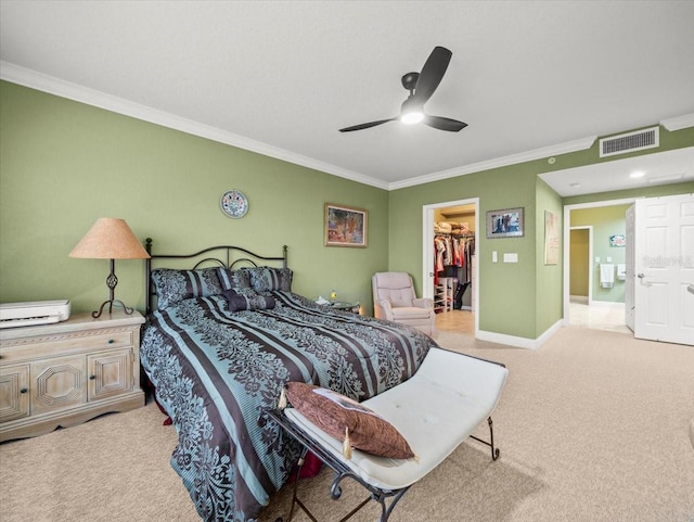 bedroom featuring ceiling fan, a spacious closet, ornamental molding, and a closet