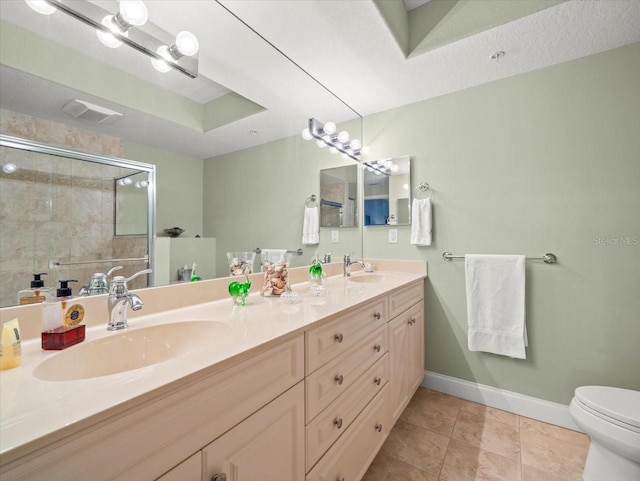 bathroom featuring toilet, tile patterned flooring, a raised ceiling, an enclosed shower, and vanity