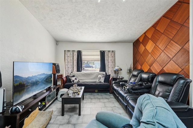 living room with a textured ceiling and wood walls