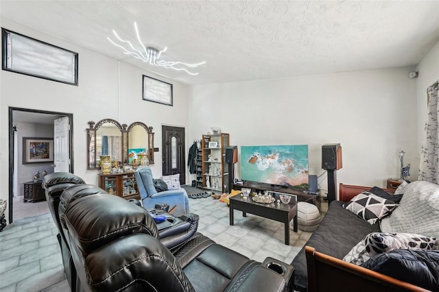 living room with a textured ceiling and a notable chandelier