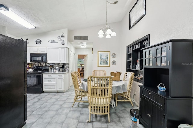 dining space featuring lofted ceiling and a chandelier