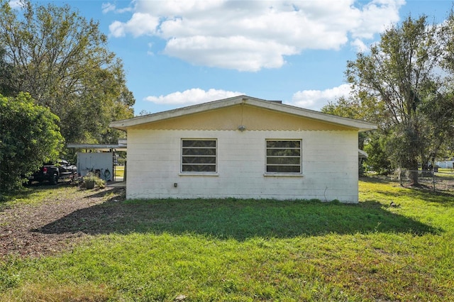 view of side of property with a yard